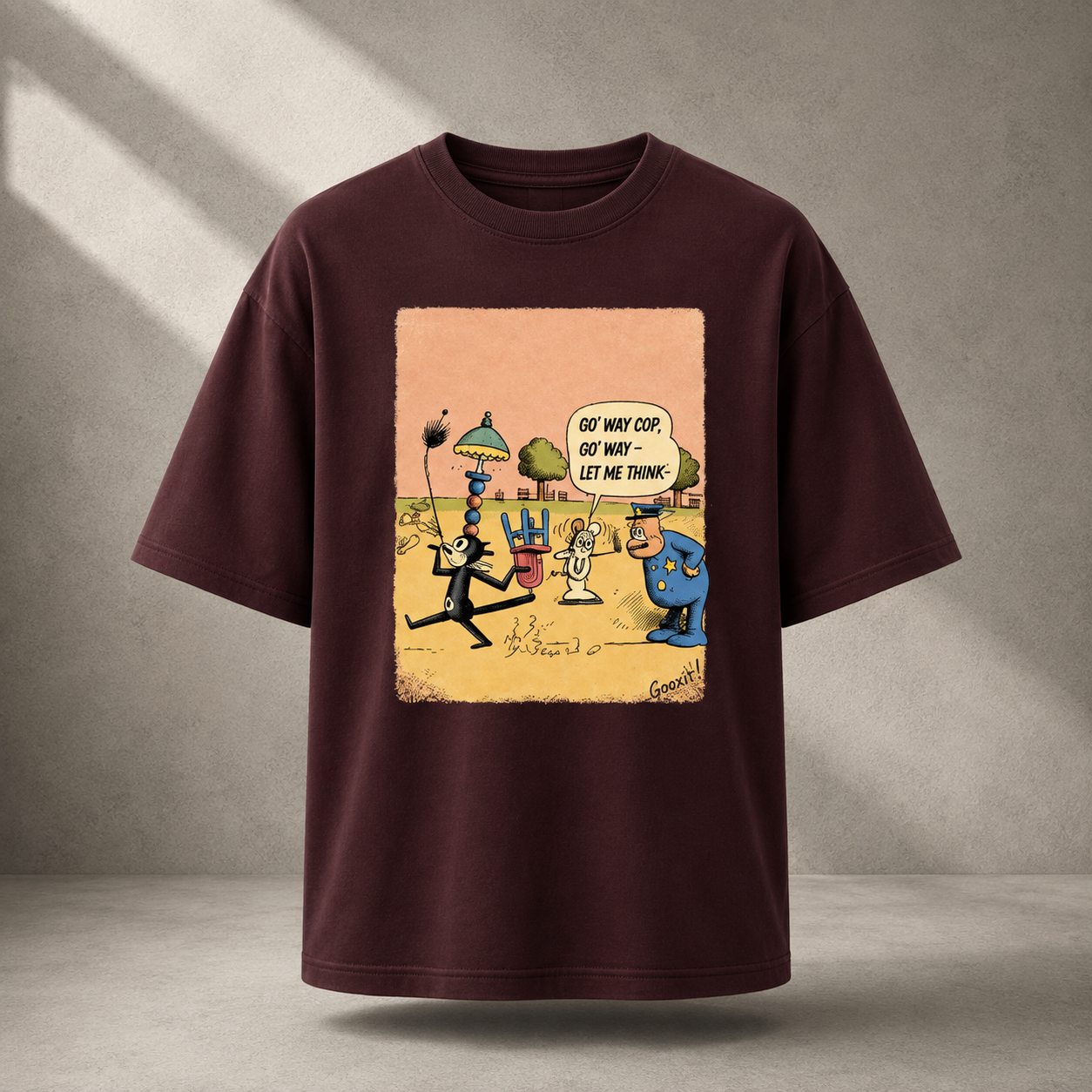 A dark maroon short-sleeve t-shirt with a large square graphic print on the front, featuring a cartoon scene with characters and a speech bubble that reads 'GOT MY WAY COF. GOT MY WAY - LET ME THINK!'.