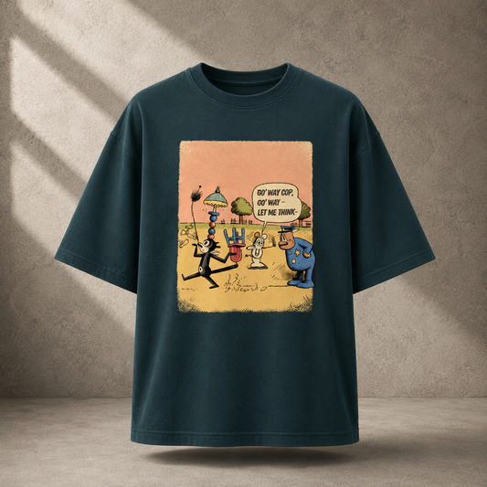 A petrol blue short-sleeve t-shirt with a vintage-style cartoon graphic on the front, displayed against a textured gray concrete wall with soft diagonal shadows.
